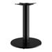 A Lancaster Table & Seating black cast iron round table base with a black pole and round base.