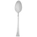 A Walco stainless steel dessert spoon with a white handle.