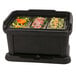 A Carlisle black top loading insulated food pan carrier with sliding lid on a table.