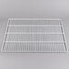 A white metal grate on a gray surface.