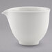 A white porcelain creamer with a handle and spout.