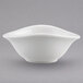 A close-up of a Villeroy & Boch white porcelain bowl with a curved edge.