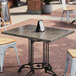 A table with Art Marble Furniture Storm Gray Quartz Tabletop on a brick patio.