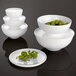 A white Villeroy & Boch bone porcelain bowl cover with olives on it.