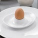 A brown egg in a Villeroy & Boch white bone porcelain egg cup.