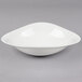 A Villeroy & Boch white porcelain deep bowl with a curved edge.