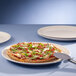 A pizza on a Villeroy & Boch white porcelain plate.