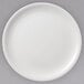 A white Villeroy & Boch porcelain plate with a white rim on a gray surface.