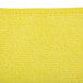 A yellow Unger SmartColor microfiber cleaning cloth with a small hole in it.