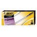 A yellow and black box of Bic Cristal Xtra Smooth black medium point pens.