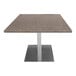 A 30" x 60" Art Marble Furniture quartz table top in storm gray on a table with a metal base.