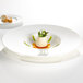 A white Villeroy & Boch bone porcelain deep plate with food on it.