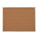 A wooden cork board with a natural oak frame.