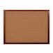 An Aarco cherry wood framed cork board.