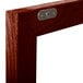 A close-up of a wood frame with a metal latch.