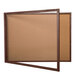A brown wooden enclosed display case with a glass door.