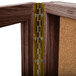 An Aarco walnut wood display case with brass hinges.