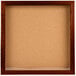 An enclosed cork board with a wooden frame.