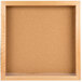 An Aarco wooden enclosed bulletin board with a cork board inside.
