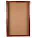 A cork board with a wooden frame.