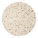 A close up of a white Art Marble Furniture round quartz tabletop with small holes in it.