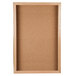 An Aarco natural oak enclosed cork board with a wooden frame.