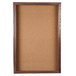 A cork board with a walnut wooden frame.