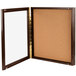 An Aarco walnut framed cork board.