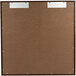 A brown board with a metal frame and metal clips.