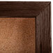 A walnut-framed cork bulletin board.