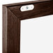 A close-up of a walnut wood frame.