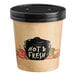 A paper container with a black lid on a counter with the words "Hot and Fresh"