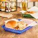 A blue Choice rectangular plastic fast food basket with food in it.