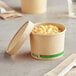 A close-up of a EcoChoice paper container with macaroni and cheese inside.