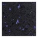A close-up of an Art Marble Furniture blue galaxy quartz table top with black and blue speckles.