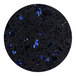 A black and blue speckled circle with blue specks on a black surface.