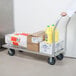 A person pushing a Regency mobile dunnage rack with boxes on it.