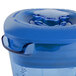 A close-up of a blue Waring blender jar with a lid.