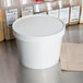 A white Choice paper food container with a lid.