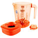 The Waring Raptor orange blender jar with lid on a blender.