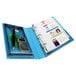 A blue Avery Protect and Store mini binder with a calculator and pen inside.