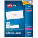 A blue box of white Avery mailing address labels with a black border.