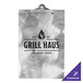 A silver metal Menu Solutions clipboard with black swirls and the words "Grill Haus" on it.