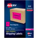 A cardboard box with a pink label that reads "Avery 5 1/2" x 8 1/2" Neon Magenta Shipping Labels" in black text.