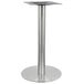 A round stainless steel bar height table base.