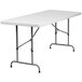 A Flash Furniture white rectangular folding table with metal legs.