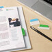 A close-up of a laptop with Avery Ultra Tabs on a book.