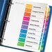 A blue binder with Avery multi-color table of contents dividers inside.