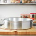 A large metal Vollrath Wear-Ever Classic Select brazier pan.