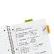 A notebook with Avery Ultra Tabs in assorted neon colors with writing on them.